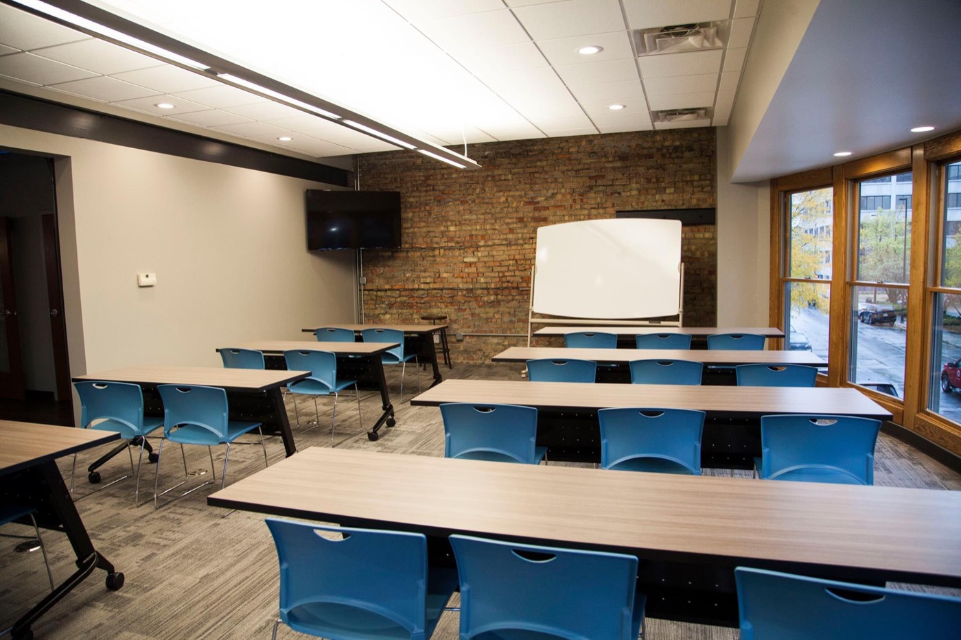 Atrium training room with tables and blue chairs